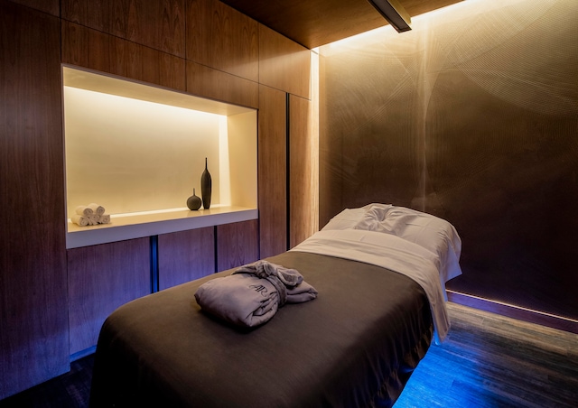 bedroom featuring wood walls and dark hardwood / wood-style floors