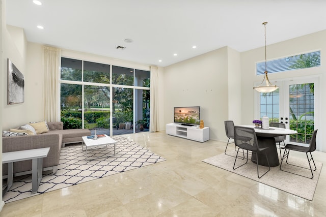 living room with french doors and floor to ceiling windows