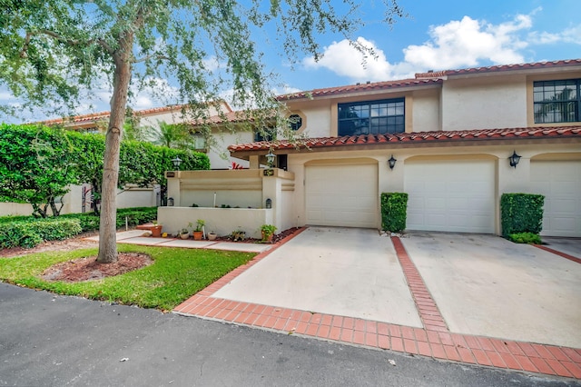 mediterranean / spanish house with a garage