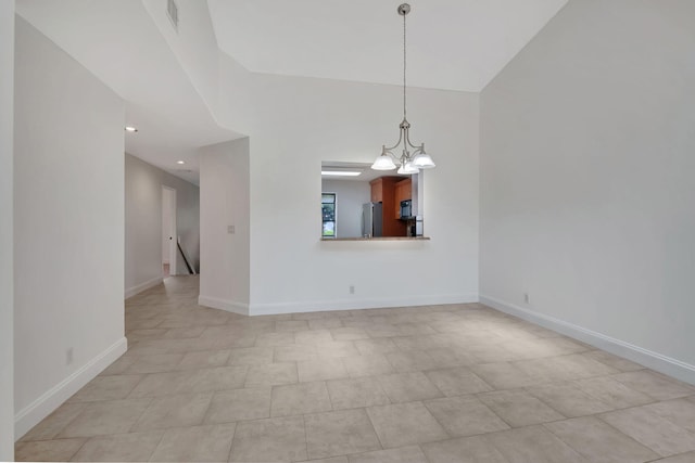 unfurnished dining area with a notable chandelier and light tile patterned floors