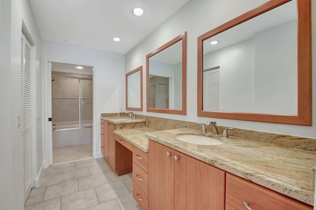 bathroom featuring vanity, bath / shower combo with glass door, and tile patterned floors