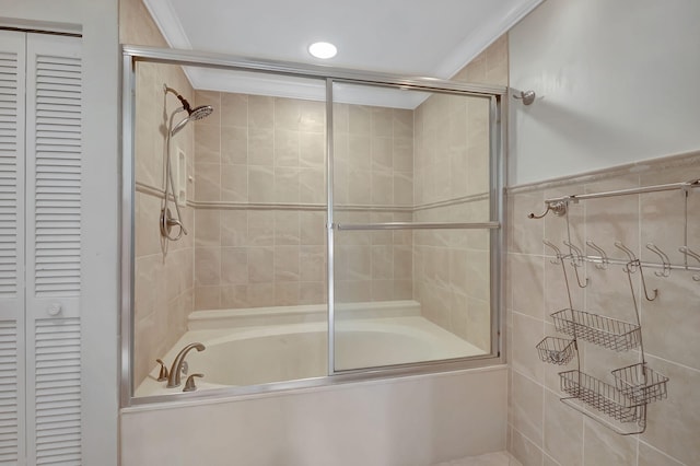 bathroom with crown molding and shower / bath combination with glass door