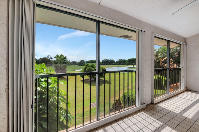 unfurnished sunroom featuring a water view