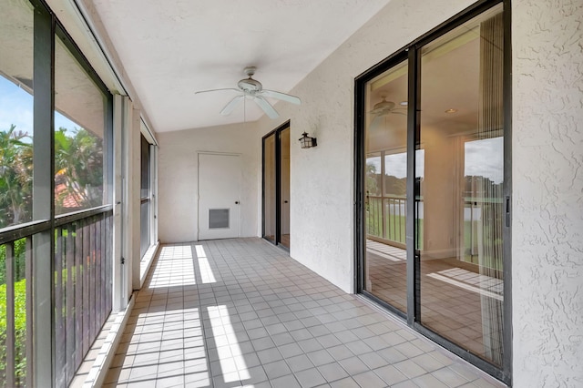 unfurnished sunroom with lofted ceiling and ceiling fan