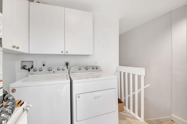 washroom featuring independent washer and dryer and cabinets