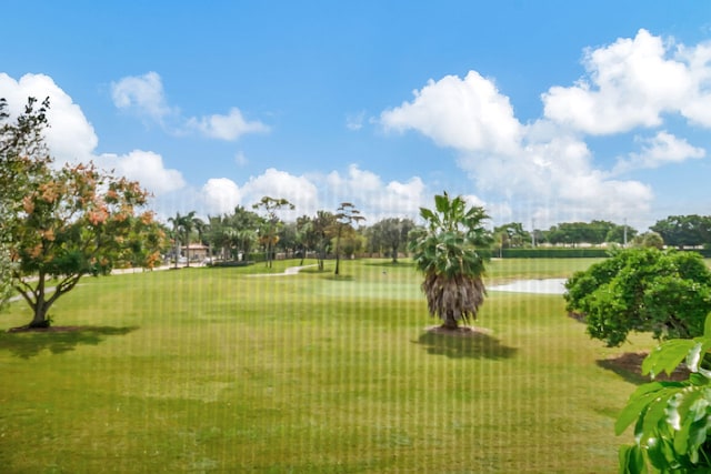 view of property's community with a yard and a water view