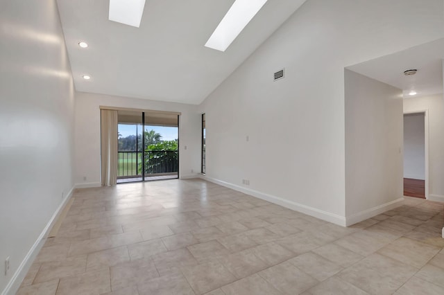 empty room with high vaulted ceiling and a skylight