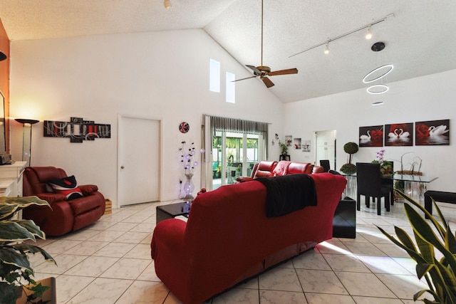 living room with a textured ceiling, high vaulted ceiling, ceiling fan, and light tile patterned flooring