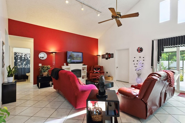 tiled living room with high vaulted ceiling and ceiling fan