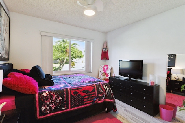 bedroom with a textured ceiling and ceiling fan