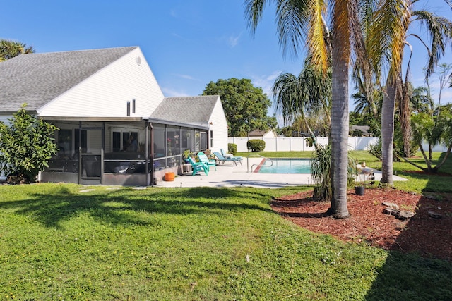 exterior space featuring a patio area, a sunroom, and a lawn