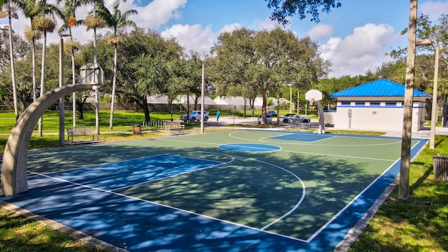 view of sport court featuring a lawn