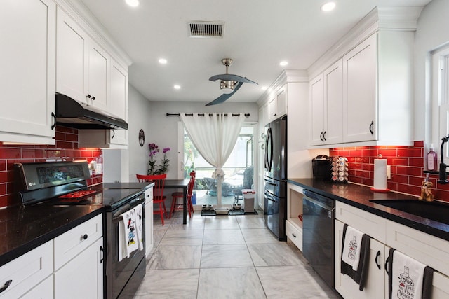 kitchen featuring white cabinetry, black appliances, sink, and tasteful backsplash