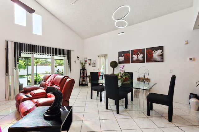 dining room featuring high vaulted ceiling, a textured ceiling, and light tile patterned floors