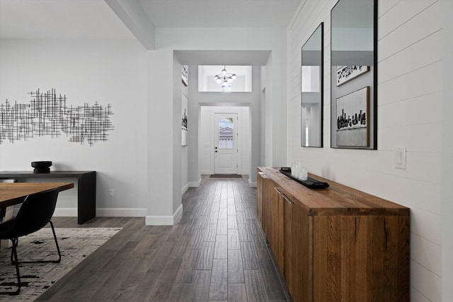 foyer featuring dark hardwood / wood-style flooring and a notable chandelier