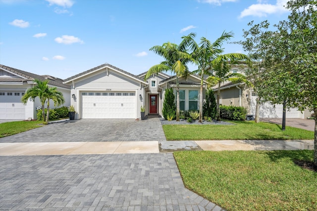 ranch-style house featuring a garage and a front yard