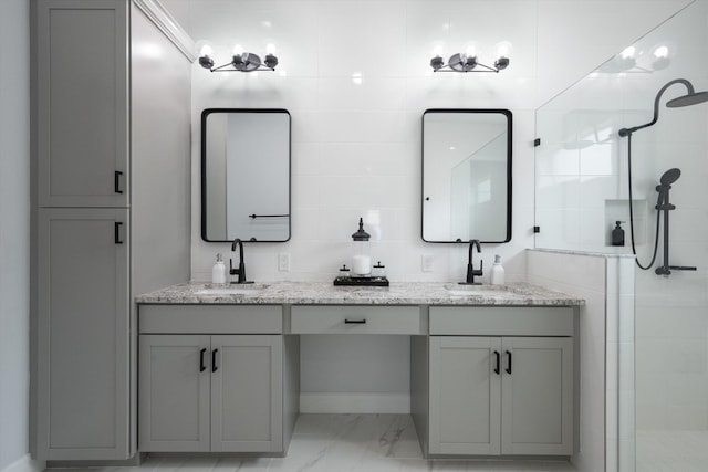 bathroom with a shower with door and vanity