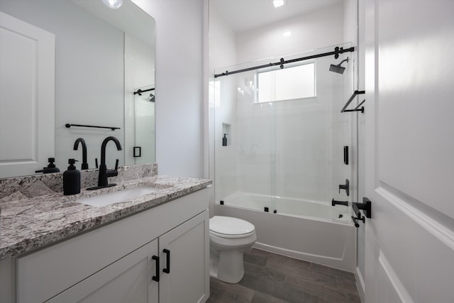 full bathroom featuring shower / bath combination with glass door, vanity, and toilet