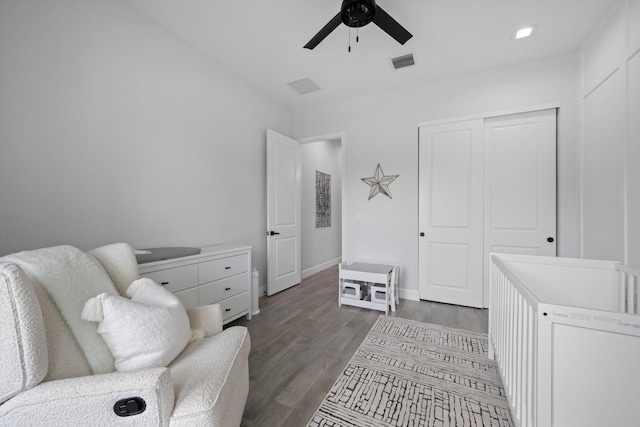 living area with ceiling fan and dark hardwood / wood-style flooring