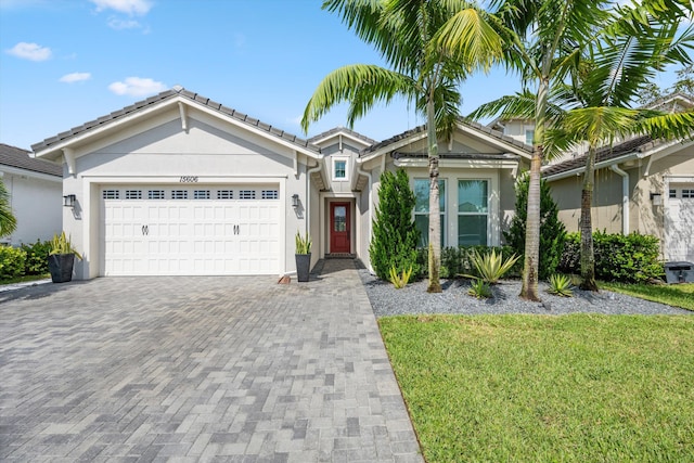 view of front of home with a front yard and a garage