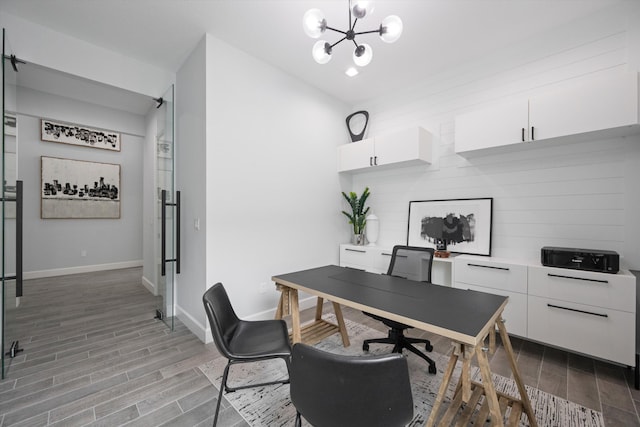 office space featuring lofted ceiling and a notable chandelier