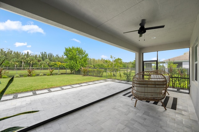 unfurnished sunroom with ceiling fan