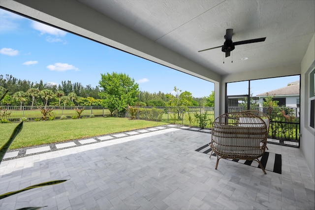 unfurnished sunroom featuring ceiling fan