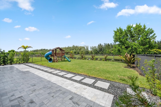 exterior space with a playground and a patio