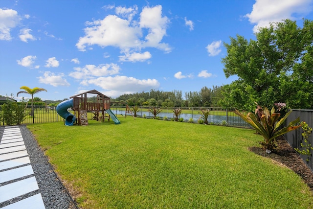 view of yard with a water view and a playground