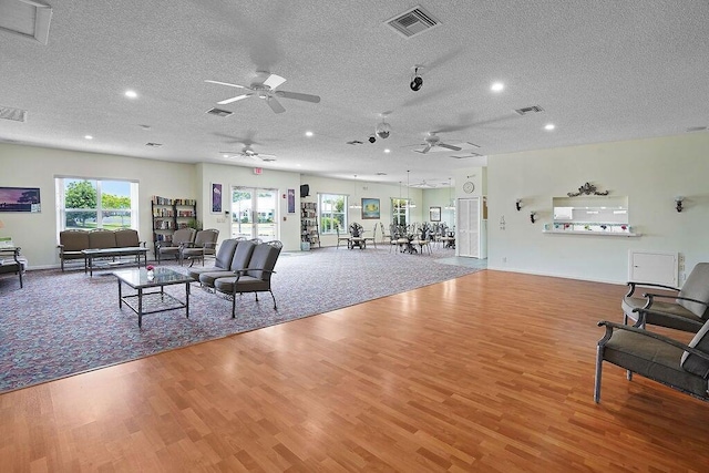 living room featuring hardwood / wood-style floors and a textured ceiling