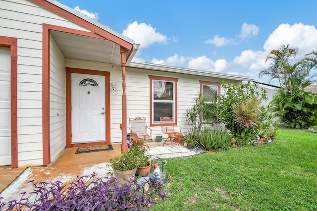 single story home featuring a garage and a front yard