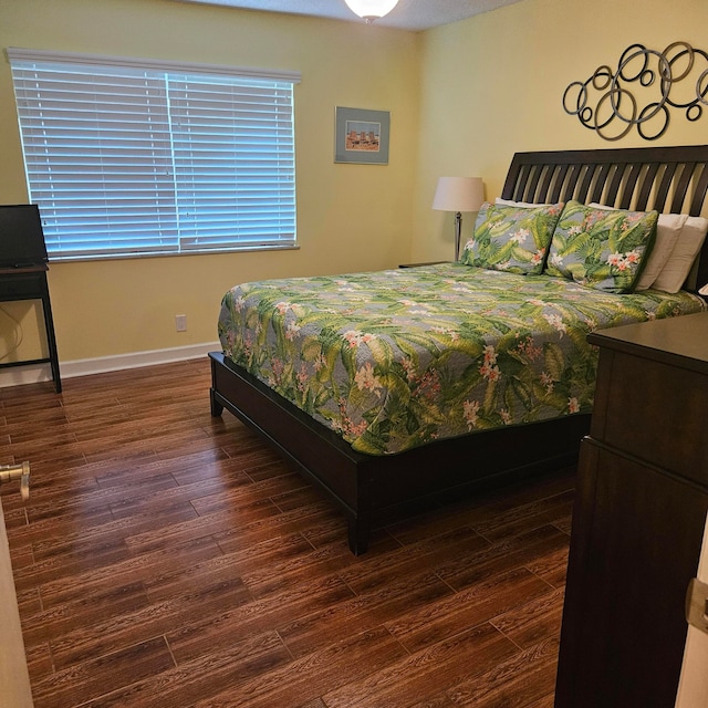 bedroom with dark wood-type flooring