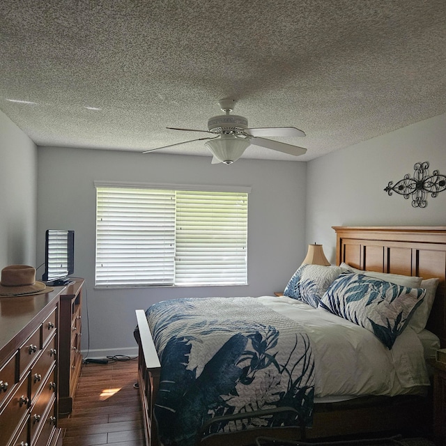 bedroom with ceiling fan, multiple windows, dark hardwood / wood-style flooring, and a textured ceiling