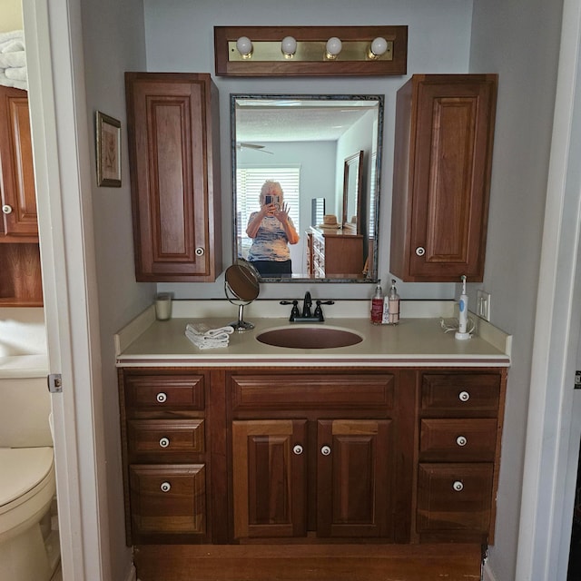 bathroom featuring vanity and toilet