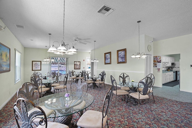 carpeted dining room featuring ceiling fan and a textured ceiling