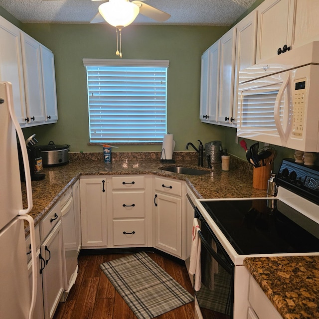 kitchen featuring white cabinets, white appliances, dark hardwood / wood-style floors, and sink