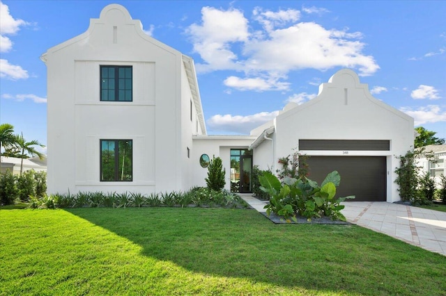 view of front facade featuring a garage and a front lawn