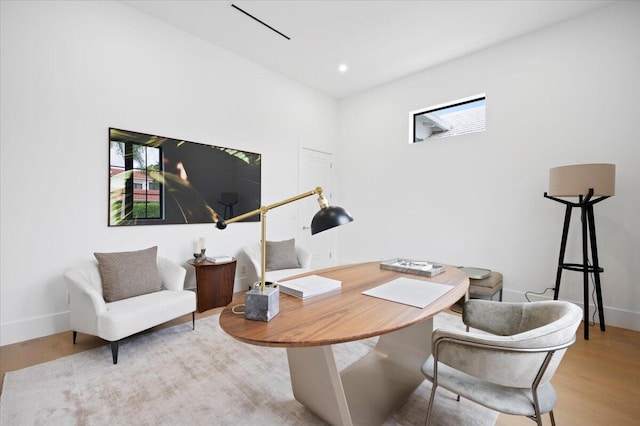 home office with light hardwood / wood-style floors