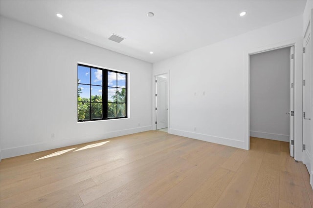 unfurnished room with light wood-type flooring