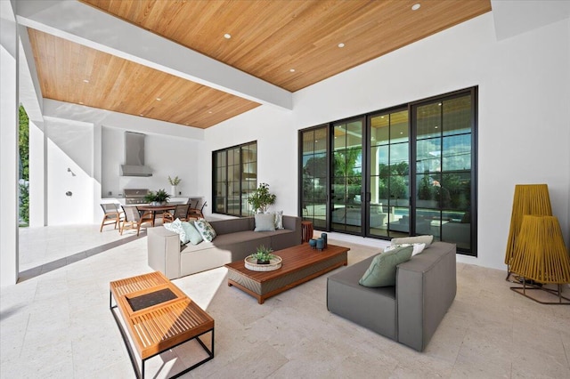 living room featuring beam ceiling and wooden ceiling