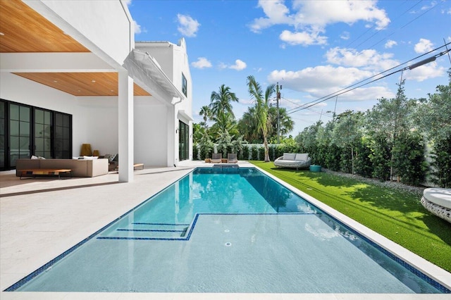 view of pool with a patio area, a lawn, and outdoor lounge area