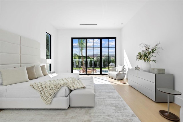 bedroom featuring light hardwood / wood-style floors and access to exterior