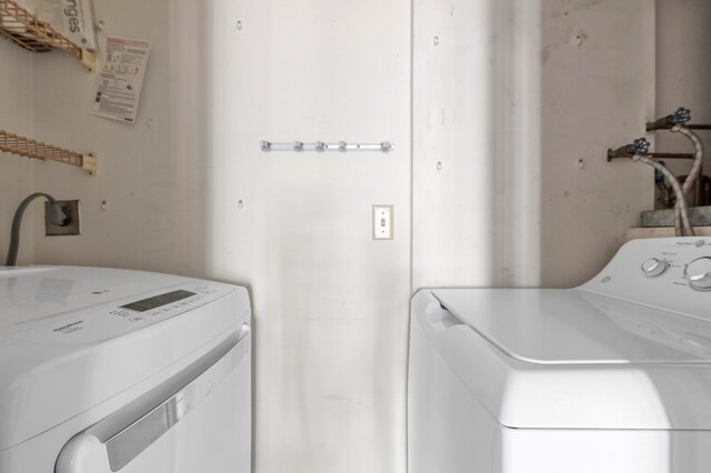 clothes washing area featuring washer and dryer