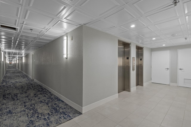 hallway with elevator, baseboards, and recessed lighting