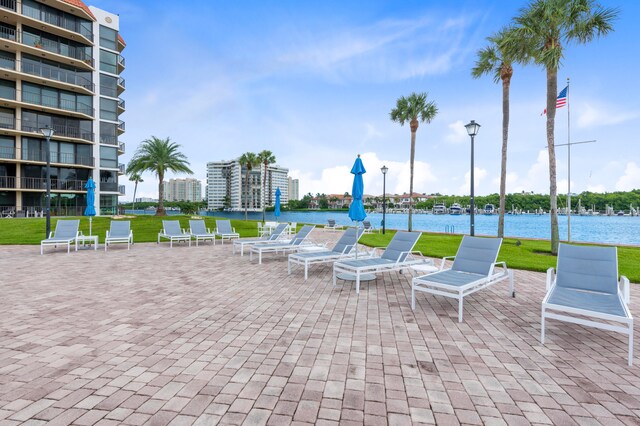 view of patio featuring a balcony and a water view