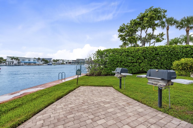 view of patio / terrace with a grill and a water view