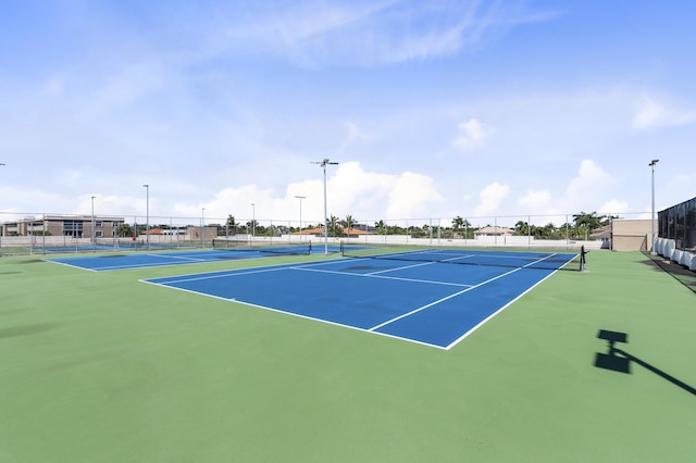 view of tennis court featuring fence