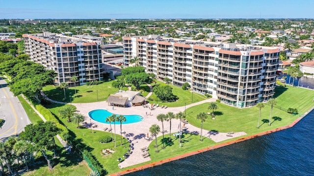 aerial view of apartment complex, a pool, and a nearby body of water