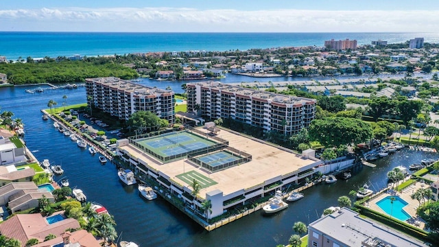 drone / aerial view of a nearby body of water and apartment complex