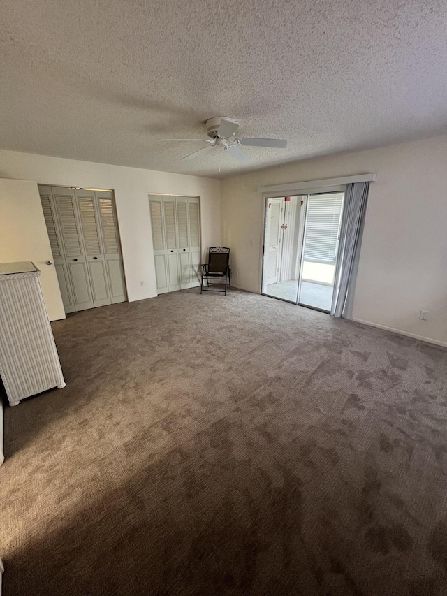 13 Lake Vista Trl Unit 205, Port Saint Lucie, FL 34952 - unfurnished bedroom with carpet, multiple closets, a textured ceiling, and a ceiling fan